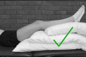 Pillows stacked for elevation in joint replacement recovery